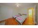 Bedroom featuring two beds, hardwood floors, neutral walls, and a ceiling fan at 3016 Boston Ave, Charlotte, NC 28212