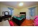 Bedroom features wood floors, a large bed, and plenty of natural light at 3016 Boston Ave, Charlotte, NC 28212
