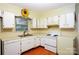 Well-lit kitchen featuring white cabinets and vintage appliances at 3016 Boston Ave, Charlotte, NC 28212