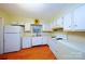 Bright kitchen featuring white appliances, white cabinets and updated flooring at 3016 Boston Ave, Charlotte, NC 28212