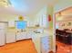 Cozy kitchen with white cabinets, appliances and an opening into the dining room at 3016 Boston Ave, Charlotte, NC 28212