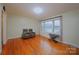 Bright living room with hardwood floors, a large window, and neutral wall color at 3016 Boston Ave, Charlotte, NC 28212