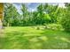 Spacious and sunny backyard, surrounded by nature offers ample space for outdoor activities at 3988 Old Hickory Rd, Lancaster, SC 29720