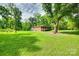 Large grassy backyard framed by mature trees, offering privacy and space at 3988 Old Hickory Rd, Lancaster, SC 29720