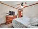 Bright bedroom with wooden trim, ceiling fan and dresser with flat screen TV at 3988 Old Hickory Rd, Lancaster, SC 29720