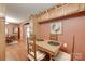 Inviting dining area with hardwood floors, quaint decor, and plenty of natural light. Rustic and charming at 3988 Old Hickory Rd, Lancaster, SC 29720