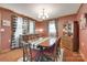 Cozy dining room featuring hardwood floors, a classic table, with decorative buffalo plaid curtains at 3988 Old Hickory Rd, Lancaster, SC 29720