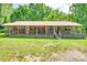 Charming single-story home with a metal roof, inviting front porch, and decorative wagon wheel accents at 3988 Old Hickory Rd, Lancaster, SC 29720