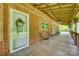 Inviting covered front porch with brick and wood accents, comfortable seating, and a welcoming entrance at 3988 Old Hickory Rd, Lancaster, SC 29720