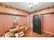 Cozy dining area with a vintage refrigerator, hardwood floors, and lots of natural light, adjacent to the kitchen at 3988 Old Hickory Rd, Lancaster, SC 29720