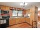 Functional kitchen with wood cabinets, modern appliances, and an adjacent dining area, perfect for Gathering meals at 3988 Old Hickory Rd, Lancaster, SC 29720