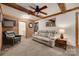 Inviting living room with exposed wood beams, brick accent wall, and cozy seating at 3988 Old Hickory Rd, Lancaster, SC 29720
