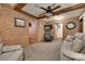 Comfortable living room with brick accent wall, wood beams, and carpet flooring at 3988 Old Hickory Rd, Lancaster, SC 29720