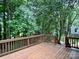 Spacious wood deck offers a peaceful view of surrounding trees at 4504 Bellmore Ct, Charlotte, NC 28269