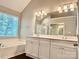 Bright bathroom boasts a soaking tub, walk-in shower, and dual sink vanity at 4504 Bellmore Ct, Charlotte, NC 28269