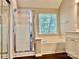 Serene bathroom with a walk-in shower and a separate soaking tub at 4504 Bellmore Ct, Charlotte, NC 28269