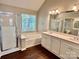 Well-lit bathroom with a dual sink vanity, walk-in shower, and soaking tub at 4504 Bellmore Ct, Charlotte, NC 28269