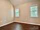 Bedroom with hardwood flooring and natural light from two windows at 4504 Bellmore Ct, Charlotte, NC 28269