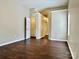 Neutral bedroom showcasing an open doorway and wood-look flooring at 4504 Bellmore Ct, Charlotte, NC 28269