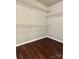 Walk-in closet with white wire shelving and modern flooring at 4504 Bellmore Ct, Charlotte, NC 28269