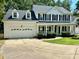 Beautiful two-story home with black shutters, a white porch, and a well-maintained lawn at 4504 Bellmore Ct, Charlotte, NC 28269