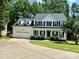 Inviting two-story home featuring a classic white exterior, black shutters, and a lovely front porch at 4504 Bellmore Ct, Charlotte, NC 28269