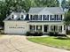 Charming two-story white home with a welcoming front porch, black shutters, and well-manicured lawn at 4504 Bellmore Ct, Charlotte, NC 28269