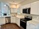 Bright kitchen showcases white cabinets, modern stainless steel appliances and light countertops at 4504 Bellmore Ct, Charlotte, NC 28269