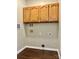 Small laundry room with upper cabinets and utility connections at 4504 Bellmore Ct, Charlotte, NC 28269