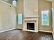 Open living room with a fireplace, hardwood floors, and plenty of natural light at 4504 Bellmore Ct, Charlotte, NC 28269