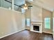 Living room featuring vaulted ceilings, a fireplace, hardwood floors, and plenty of natural light at 4504 Bellmore Ct, Charlotte, NC 28269