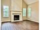 Living room features a fireplace, hardwood floors, and an abundance of natural light at 4504 Bellmore Ct, Charlotte, NC 28269