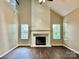 Spacious living room boasts vaulted ceiling, a fireplace, and plenty of natural light at 4504 Bellmore Ct, Charlotte, NC 28269