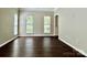 Living room featuring hardwood floors, multiple windows, and neutral paint at 4504 Bellmore Ct, Charlotte, NC 28269