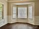 Sitting area in the house with windows, hardwood floors, chair rail, and baseboards at 4504 Bellmore Ct, Charlotte, NC 28269