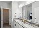 Well-lit bathroom showcasing double sinks, large mirrors, and a shower with patterned curtains at 4530 Tournette Dr # 18, Indian Land, SC 29707