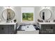 Serene bathroom featuring dual sinks, a luxurious soaking tub, and a window with greenery views at 4530 Tournette Dr # 18, Indian Land, SC 29707