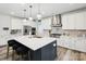 Modern kitchen features white cabinets, stainless steel appliances, a center island with seating, and stylish pendant lighting at 4530 Tournette Dr # 18, Indian Land, SC 29707