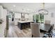 Bright kitchen with white cabinets, an island with seating, pendant lighting, and an adjacent dining area with access to the backyard at 4530 Tournette Dr # 18, Indian Land, SC 29707