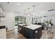 Open-concept kitchen with a dark island, white countertops, stainless steel appliances, and access to the outdoor patio at 4530 Tournette Dr # 18, Indian Land, SC 29707
