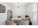 Well-lit home office with neutral tones, featuring a desk, shelving, and a motivational 