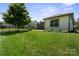 Manicured backyard with black fencing, lawn, and view of the house at 4975 Looking Glass Trl, Denver, NC 28037