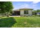 Well-maintained backyard with green grass, a patio area, and a black metal fence providing privacy at 4975 Looking Glass Trl, Denver, NC 28037