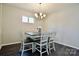 Cozy dining room featuring a modern chandelier, a neutral color palette, and wood flooring at 4975 Looking Glass Trl, Denver, NC 28037