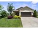 Beautiful home with a brown garage door and colorful landscaping at 4975 Looking Glass Trl, Denver, NC 28037