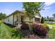 Home exterior boasts a covered porch with seating, manicured landscaping, and a two-car garage at 4975 Looking Glass Trl, Denver, NC 28037