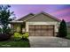 Charming home with a brown garage door, beautiful landscaping and colorful plants at 4975 Looking Glass Trl, Denver, NC 28037