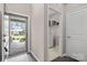 Bright foyer with wood floors, leading to laundry room and a view of the front yard at 4975 Looking Glass Trl, Denver, NC 28037