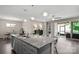 Spacious kitchen island with seating offering seamless transition to an outdoor patio and dining area at 4975 Looking Glass Trl, Denver, NC 28037