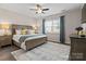 A comfortable primary bedroom with decorative lamps and plenty of natural light at 4975 Looking Glass Trl, Denver, NC 28037
